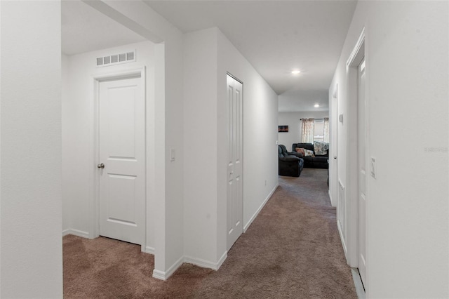 hallway featuring baseboards, carpet flooring, recessed lighting, and visible vents