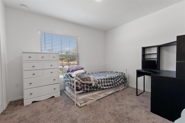 carpeted bedroom with baseboards