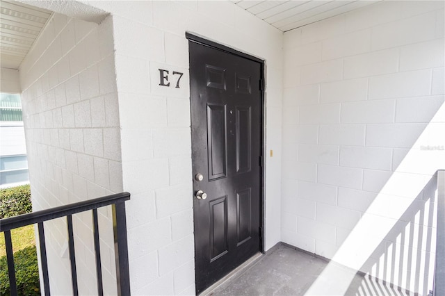 view of exterior entry with concrete block siding