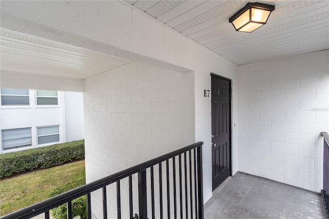entrance to property featuring concrete block siding