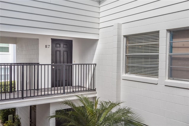 view of exterior entry featuring a balcony