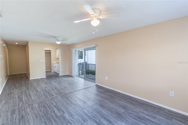 unfurnished room with baseboards, a ceiling fan, and wood finished floors