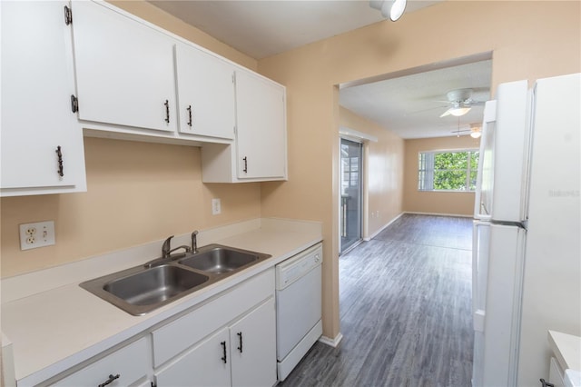 kitchen featuring a sink, light countertops, white appliances, and white cabinetry
