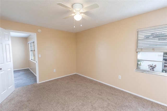 unfurnished room with baseboards, ceiling fan, and carpet flooring