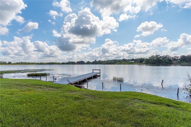 dock area featuring a water view and a yard