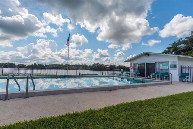 community pool featuring fence and a patio area