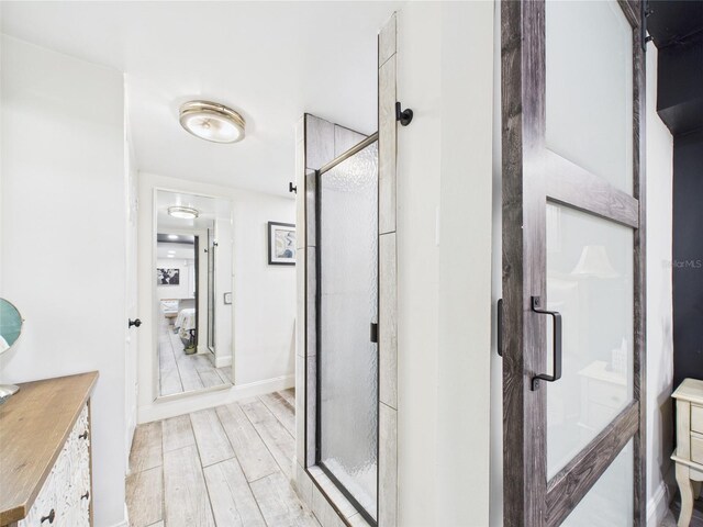 2222 12th St NW, Winter Haven, FL 33881 - bathroom with a shower stall, vanity, and wood finished floors