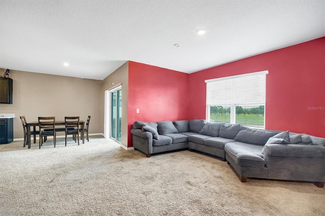 living area featuring recessed lighting, baseboards, and light carpet