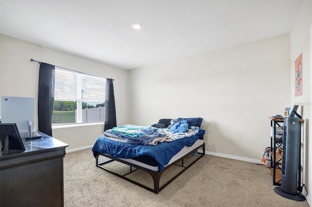 carpeted bedroom with baseboards