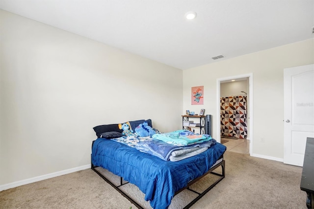 carpeted bedroom with baseboards and visible vents