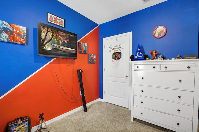 carpeted bedroom featuring baseboards and visible vents