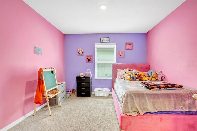 bedroom with baseboards and carpet