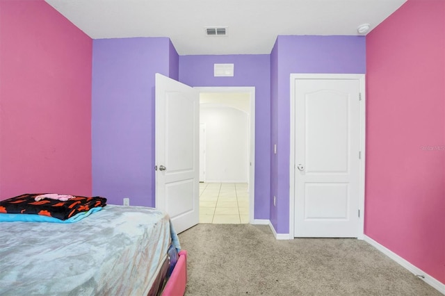carpeted bedroom featuring visible vents and baseboards