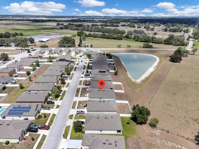 drone / aerial view with a water view and a residential view