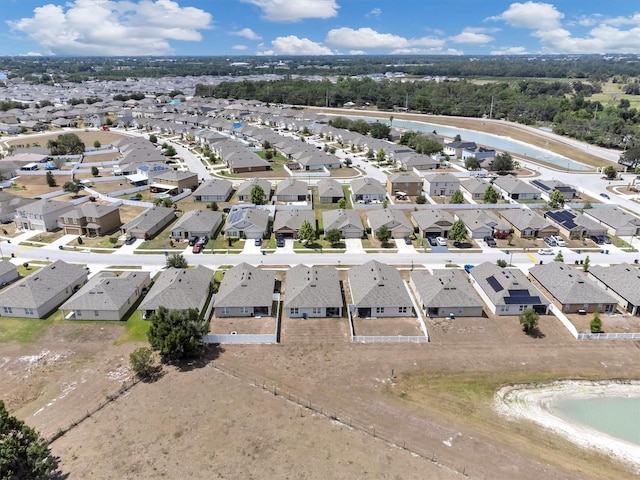 drone / aerial view featuring a residential view and a water view