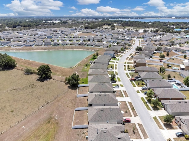 bird's eye view featuring a water view and a residential view