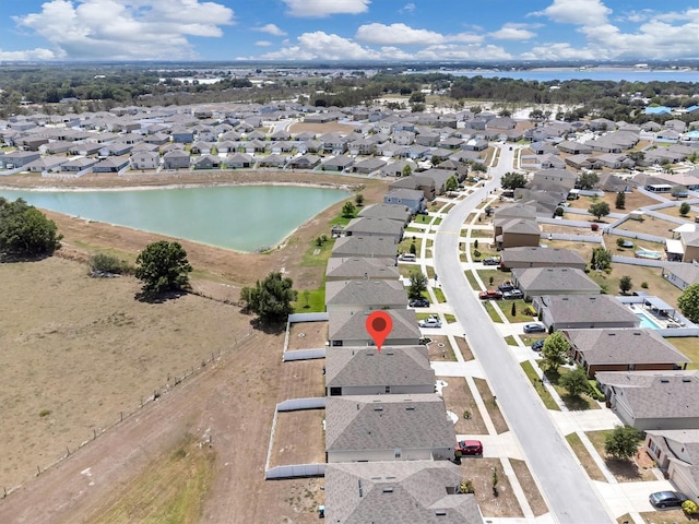 birds eye view of property with a water view and a residential view