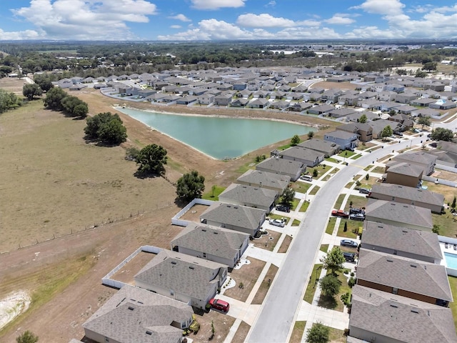 drone / aerial view featuring a residential view and a water view