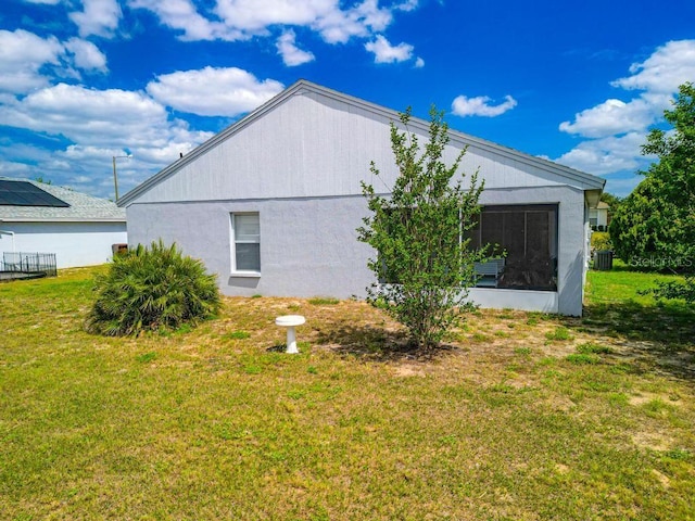 view of property exterior with a yard