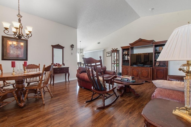 living room featuring lofted ceiling, a textured ceiling, an inviting chandelier, visible vents, and wood finished floors