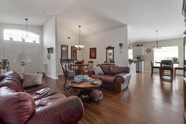 living room featuring a textured ceiling, baseboards, dark wood-style flooring, a chandelier, and lofted ceiling