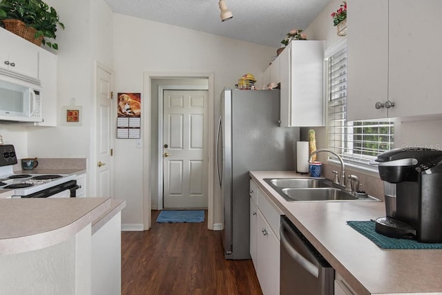 kitchen featuring a sink, light countertops, dark wood-style floors, and appliances with stainless steel finishes