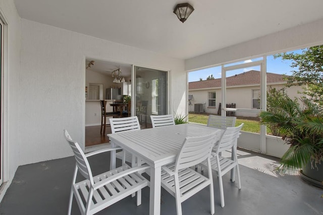sunroom featuring outdoor dining area
