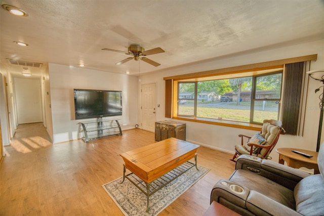 living room featuring wood finished floors, visible vents, recessed lighting, a ceiling fan, and baseboards