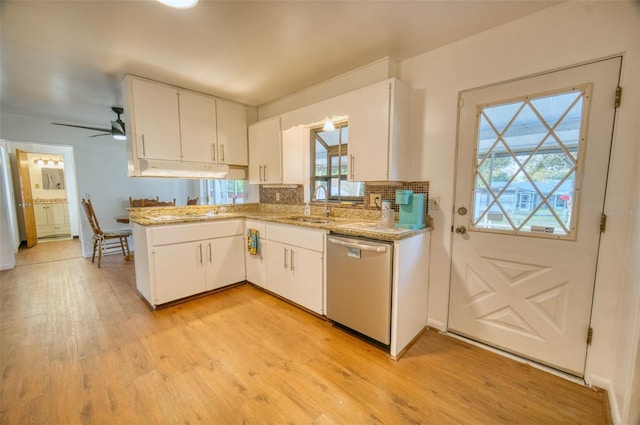 kitchen with a sink, stainless steel dishwasher, white cabinetry, and light wood-type flooring