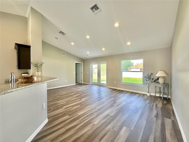 4007 Loretto Ave, Sebring, FL 33872 - unfurnished living room featuring dark wood finished floors, lofted ceiling, baseboards, recessed lighting, and french doors