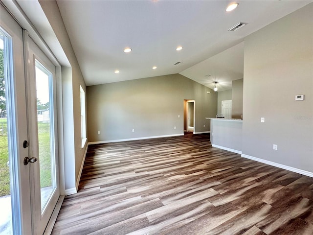 4007 Loretto Ave, Sebring, FL 33872 - unfurnished living room featuring wood finished floors, baseboards, vaulted ceiling, and recessed lighting