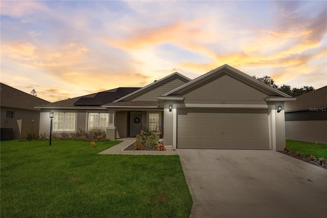 single story home with driveway, stucco siding, a front lawn, and a garage