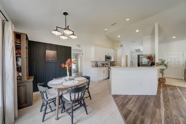dining room with vaulted ceiling, visible vents, and recessed lighting