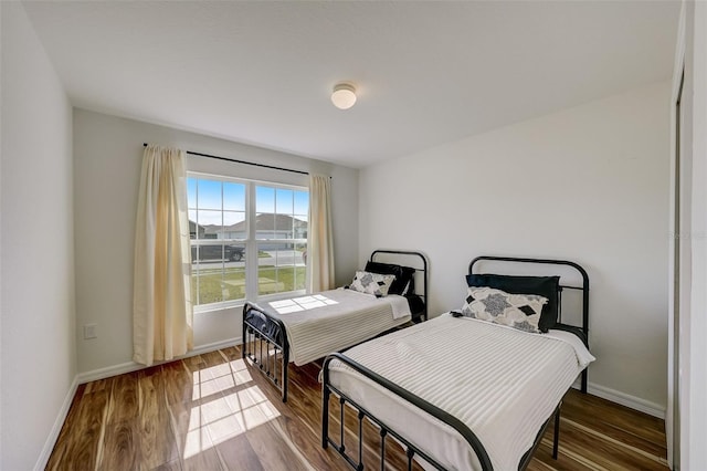 bedroom featuring baseboards and wood finished floors