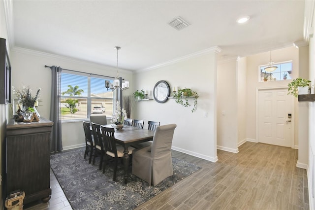 dining area with visible vents, baseboards, plenty of natural light, and a chandelier