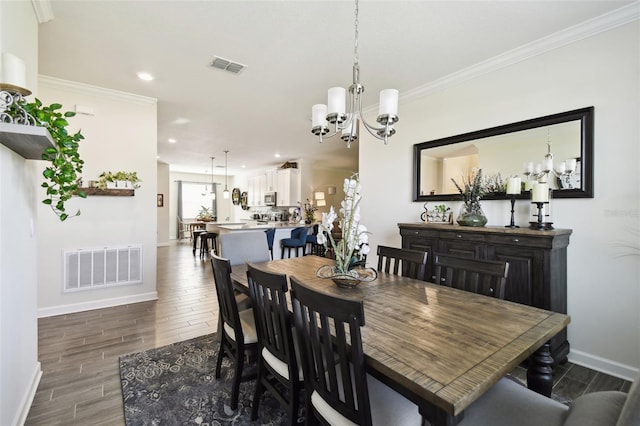 dining space featuring baseboards, an inviting chandelier, and visible vents