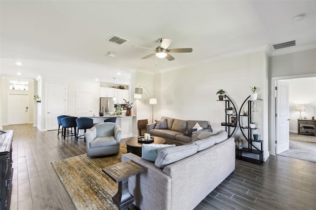 living room featuring a ceiling fan, dark wood-style floors, and visible vents