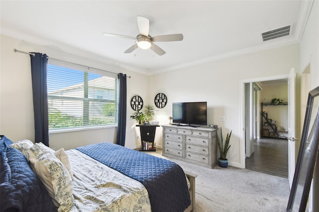 bedroom with crown molding, light carpet, a ceiling fan, baseboards, and visible vents