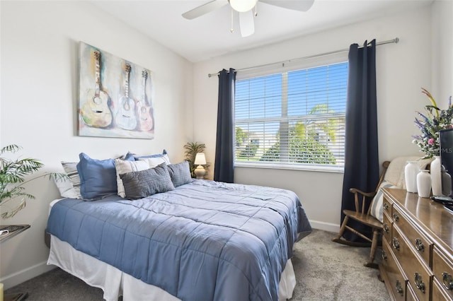 carpeted bedroom featuring baseboards and ceiling fan