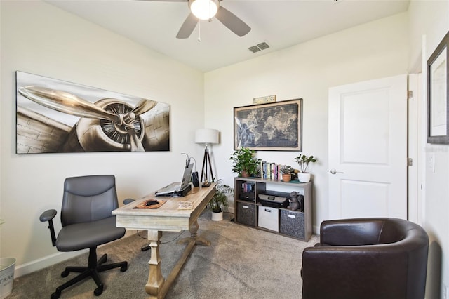 carpeted home office featuring ceiling fan and visible vents