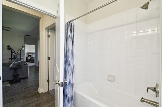 bathroom featuring visible vents, wood finished floors, and shower / bath combo