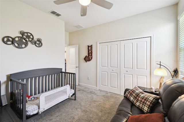 bedroom with carpet flooring, ceiling fan, visible vents, and a closet