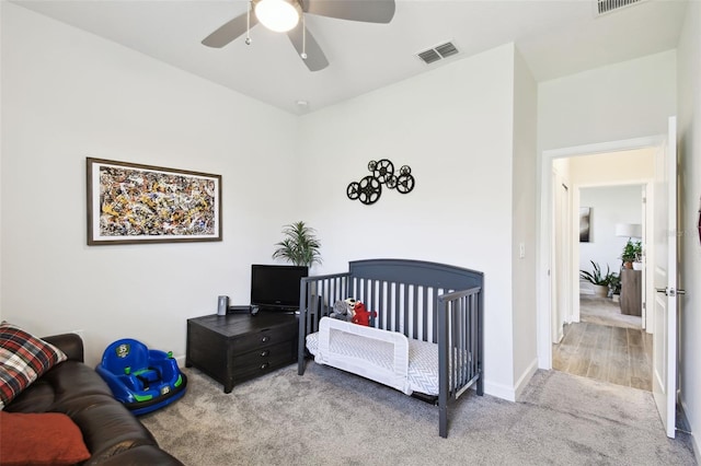 bedroom with carpet floors, baseboards, a ceiling fan, and visible vents