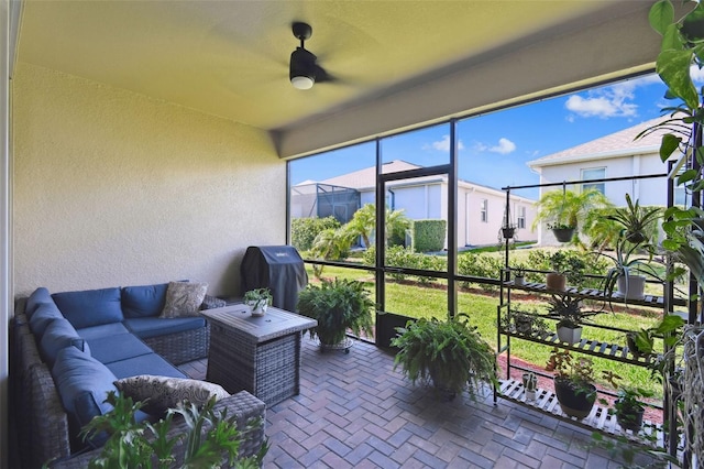 sunroom with ceiling fan and outdoor lounge area