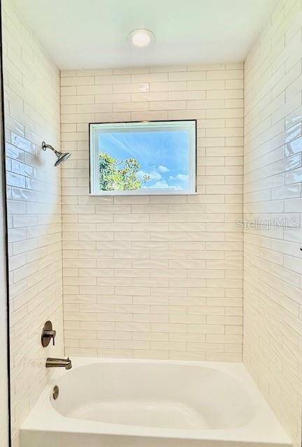 full bath featuring  shower combination