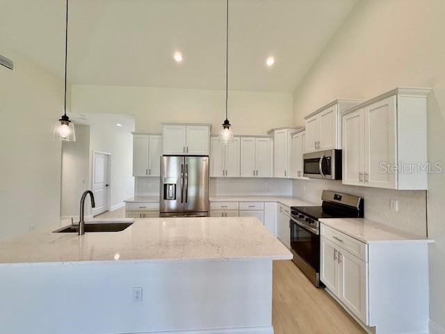 5275 Pebble Beach Dr, Sebring, FL 33872 - kitchen featuring white cabinetry, backsplash, and stainless steel appliances