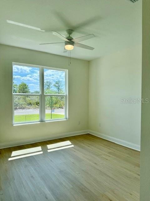 5275 Pebble Beach Dr, Sebring, FL 33872 - spare room featuring baseboards, a ceiling fan, and wood finished floors