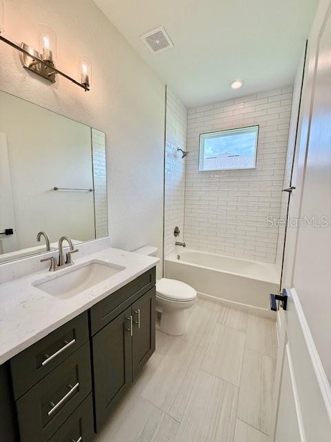 5275 Pebble Beach Dr, Sebring, FL 33872 - full bath featuring vanity, shower / bathing tub combination, visible vents, and toilet