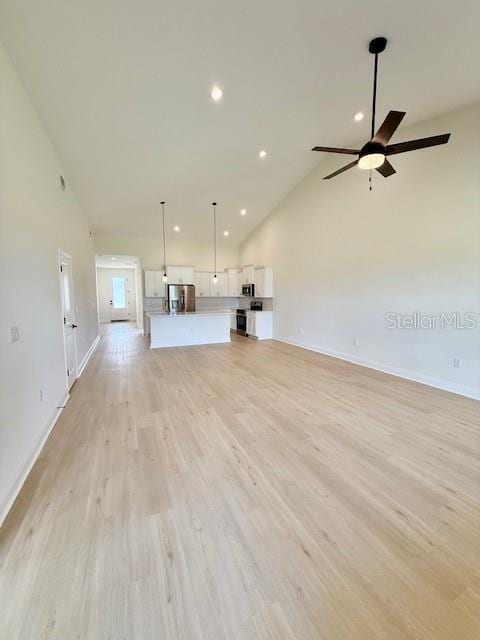 5275 Pebble Beach Dr, Sebring, FL 33872 - unfurnished living room featuring baseboards, ceiling fan, recessed lighting, and light wood-style flooring