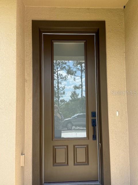 5275 Pebble Beach Dr, Sebring, FL 33872 - property entrance with stucco siding